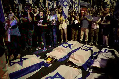 Israel-Hamas war: Mock coffins covered with the Israeli flag during a rally demanding a cease-fire deal